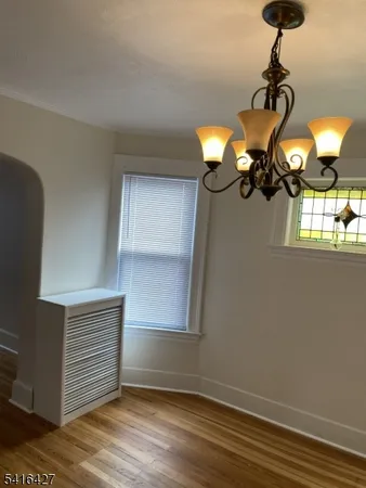 a view of a chandelier fan and wooden floor