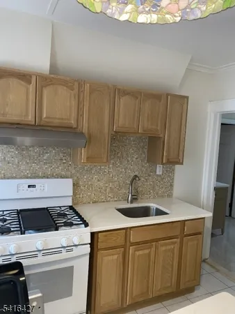 a kitchen with sink a microwave and cabinets