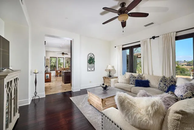 a view of an empty room with a window and a ceiling fan