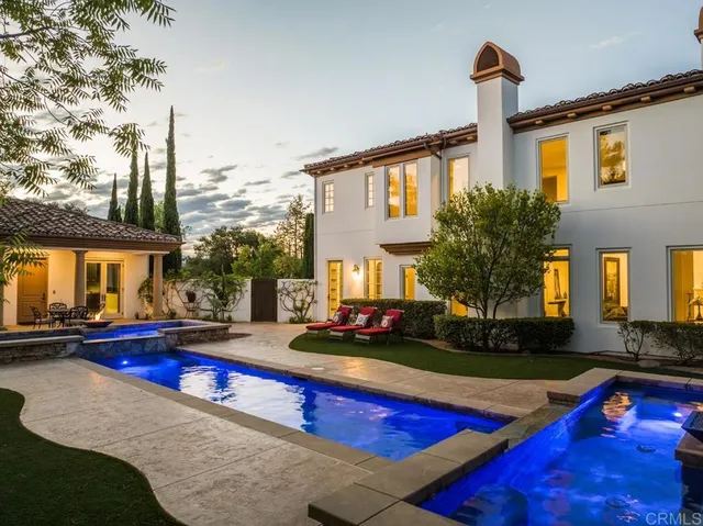 a view of swimming pool with chairs in patio