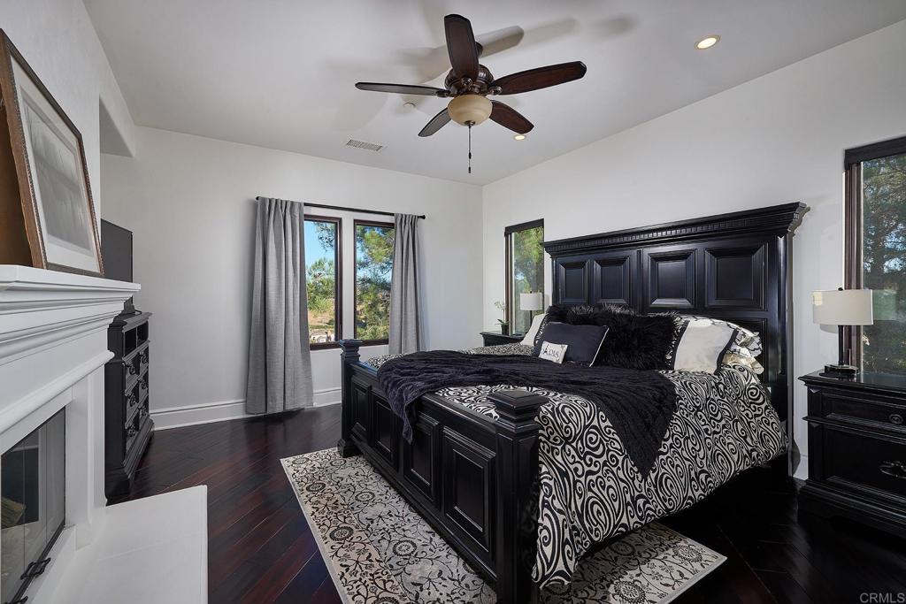 4216 Bridlewood Road Fallbrook, CA 92028 - Photo 36 of 71 a bed sitting in a bedroom next to a window with a chandelier