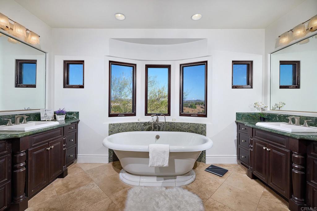 4216 Bridlewood Road Fallbrook, CA 92028 - Photo 37 of 71 a spacious bathroom with a tub sink and mirror