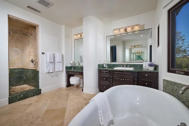 a kitchen with stainless steel appliances granite countertop a sink and a white cabinets