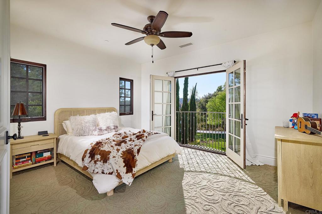 4216 Bridlewood Road Fallbrook, CA 92028 - Photo 41 of 71 a bedroom with a bed painting and a large window