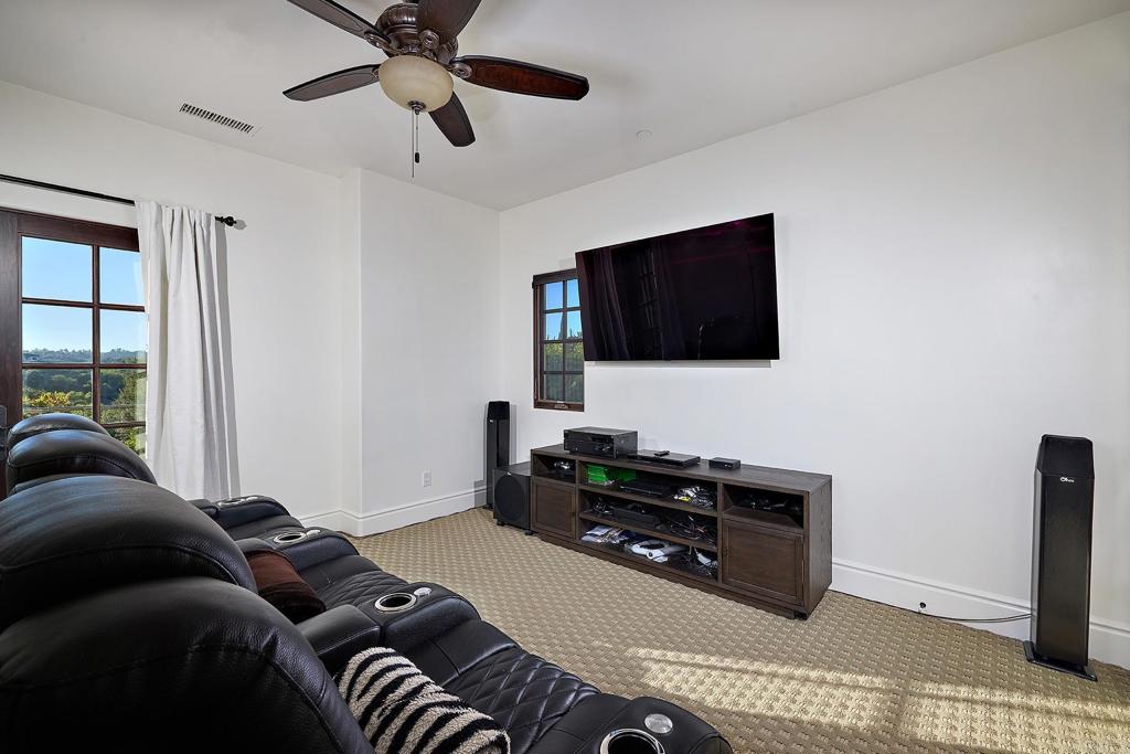4216 Bridlewood Road Fallbrook, CA 92028 - Photo 46 of 71 a living room with furniture and a flat screen tv