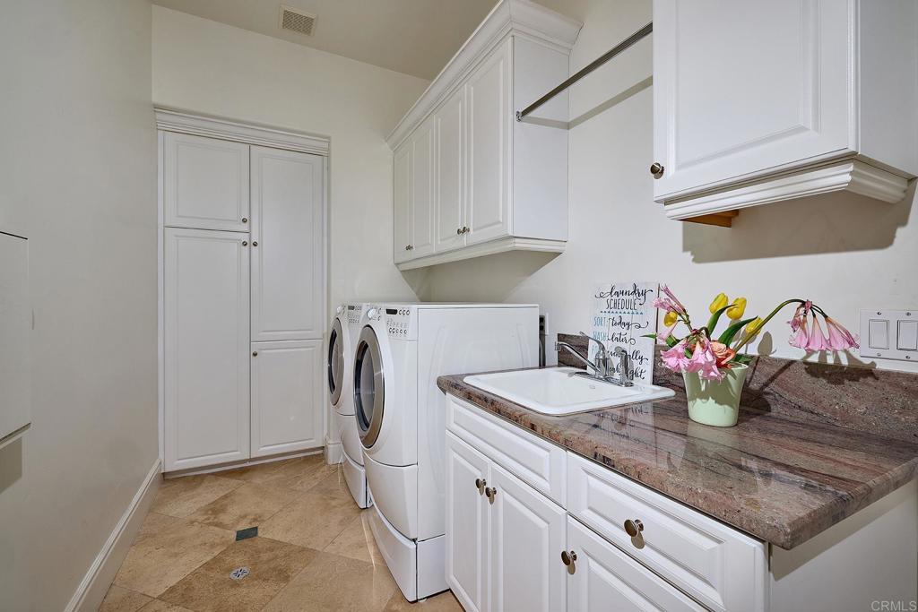 4216 Bridlewood Road Fallbrook, CA 92028 - Photo 49 of 71 a kitchen with stainless steel appliances granite countertop a sink and a white cabinets