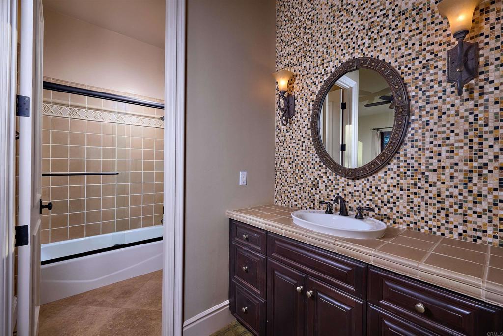 4216 Bridlewood Road Fallbrook, CA 92028 - Photo 58 of 71 a bathroom with a sink a mirror and a shower
