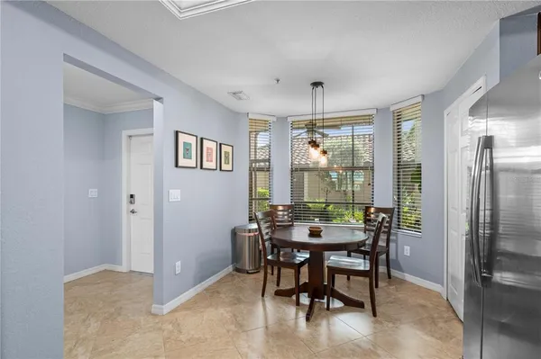 a kitchen with stainless steel appliances granite countertop refrigerator a sink dishwasher a stove top oven a refrigerator with wooden cabinets and a granite counter top