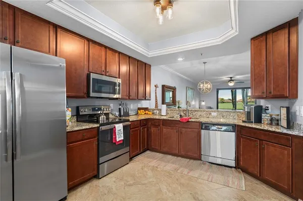 a kitchen with granite countertop a sink cabinets and wooden floor