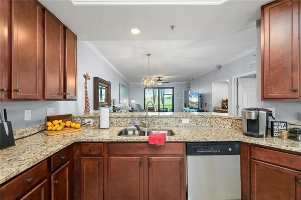 a kitchen with kitchen island granite countertop stainless steel appliances and sink