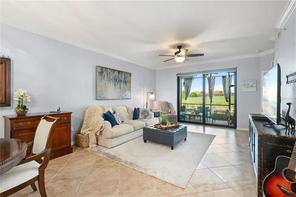 a living room with furniture and kitchen view
