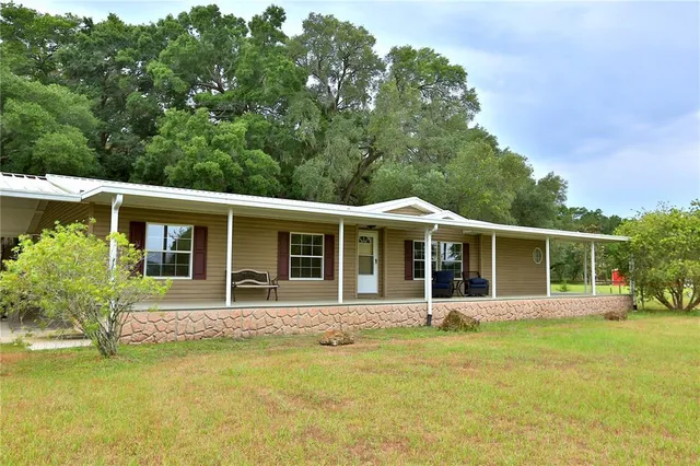 a front view of a house with swimming pool having outdoor seating
