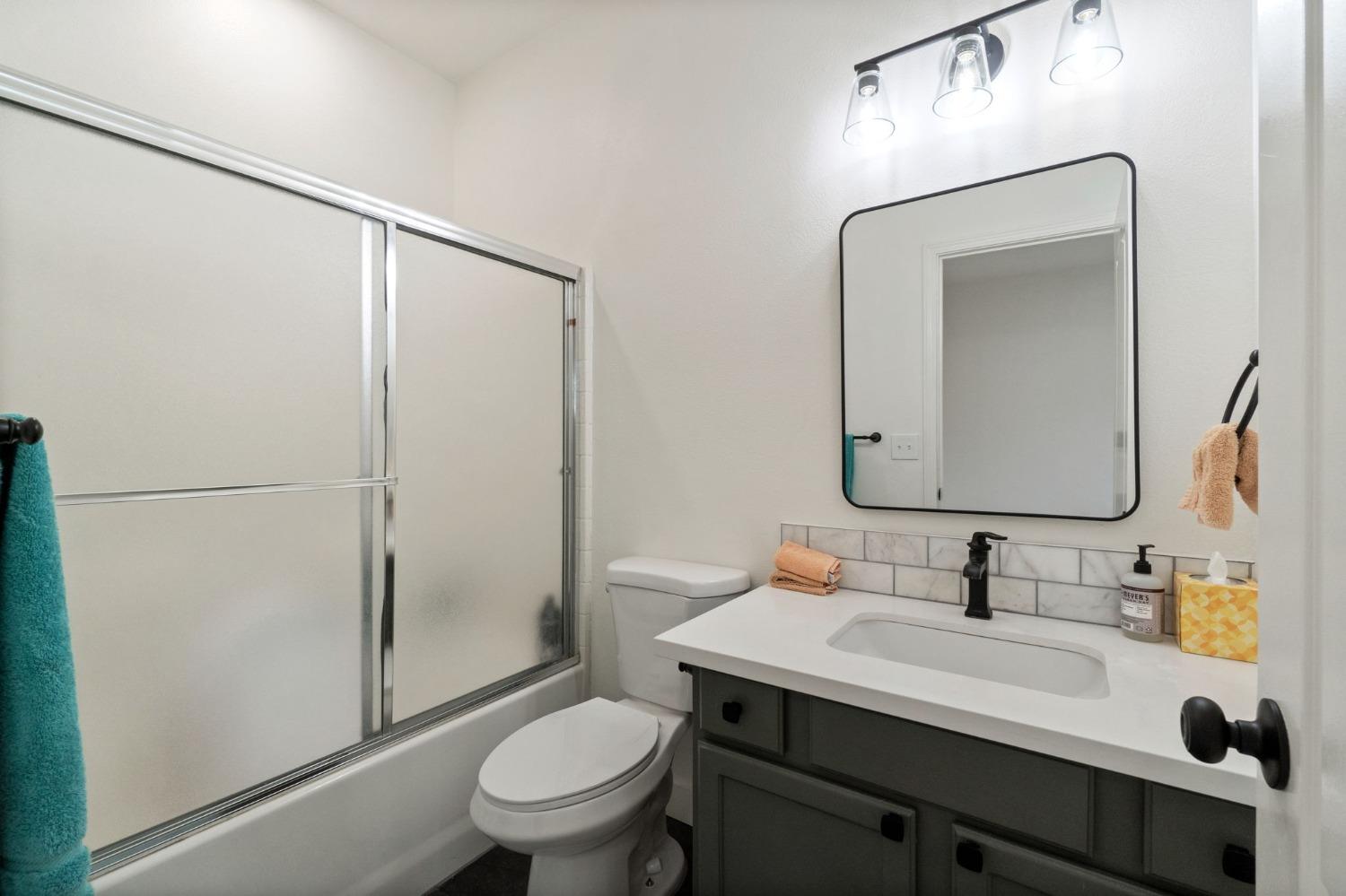 1732 North Avignon Lane Clovis, CA 93619 - Photo 19 of 28 a bathroom with a sink toilet and shower