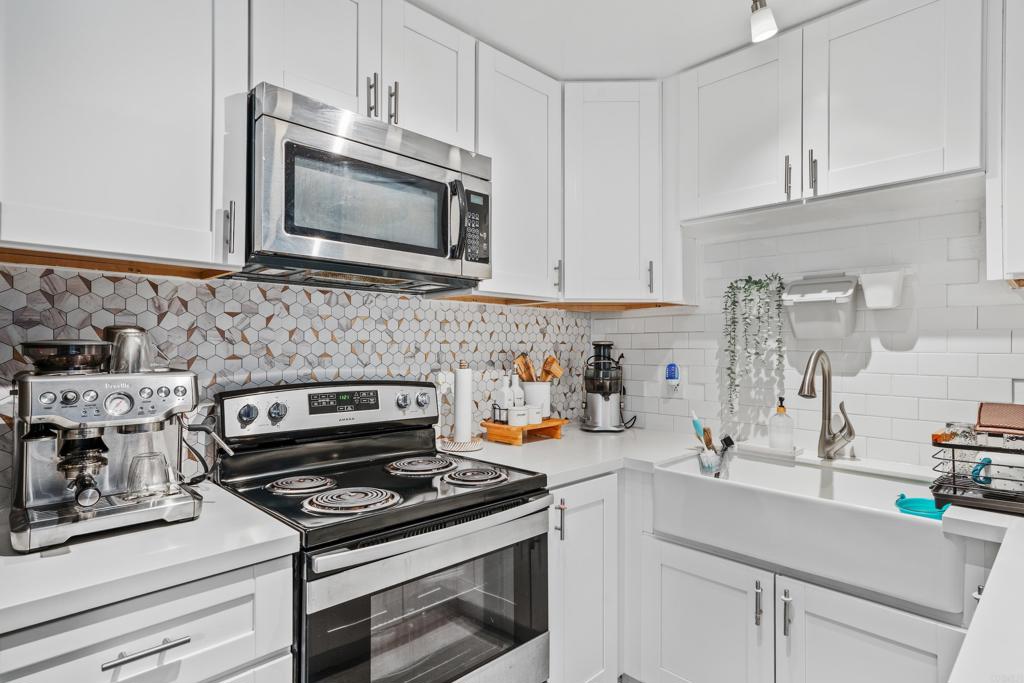 a kitchen with stainless steel appliances granite countertop a stove and a microwave