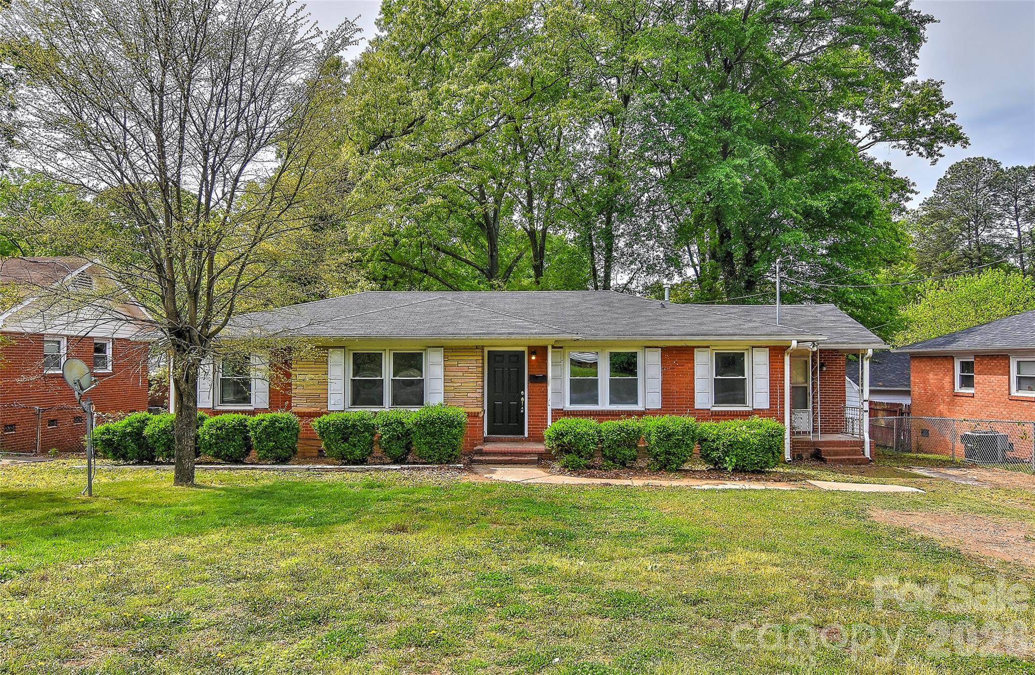 a front view of house with yard and green space
