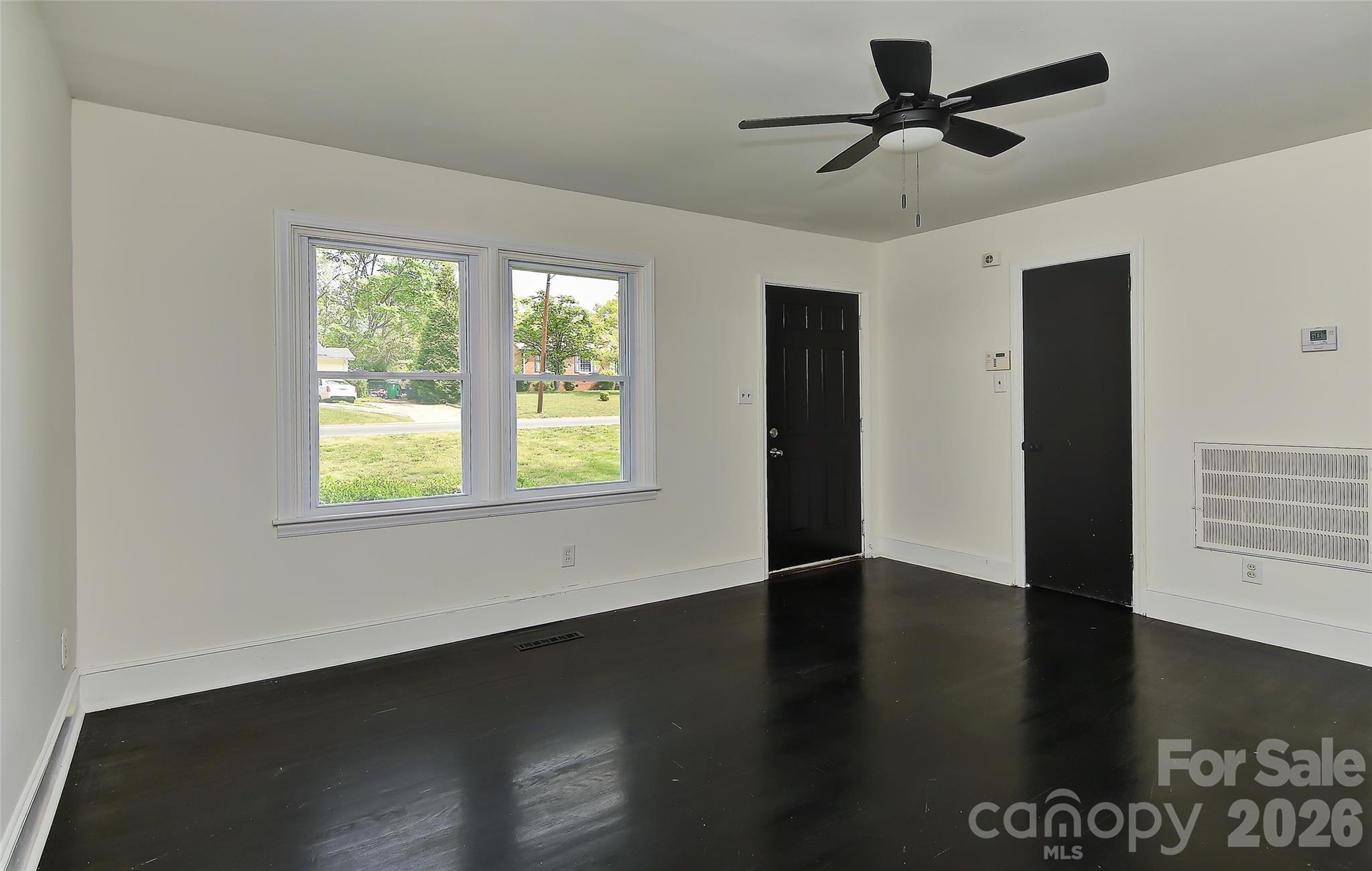 961 Clanton Road Charlotte, NC 28217 - Photo 15 of 23 a view of empty room with wooden floor and fan