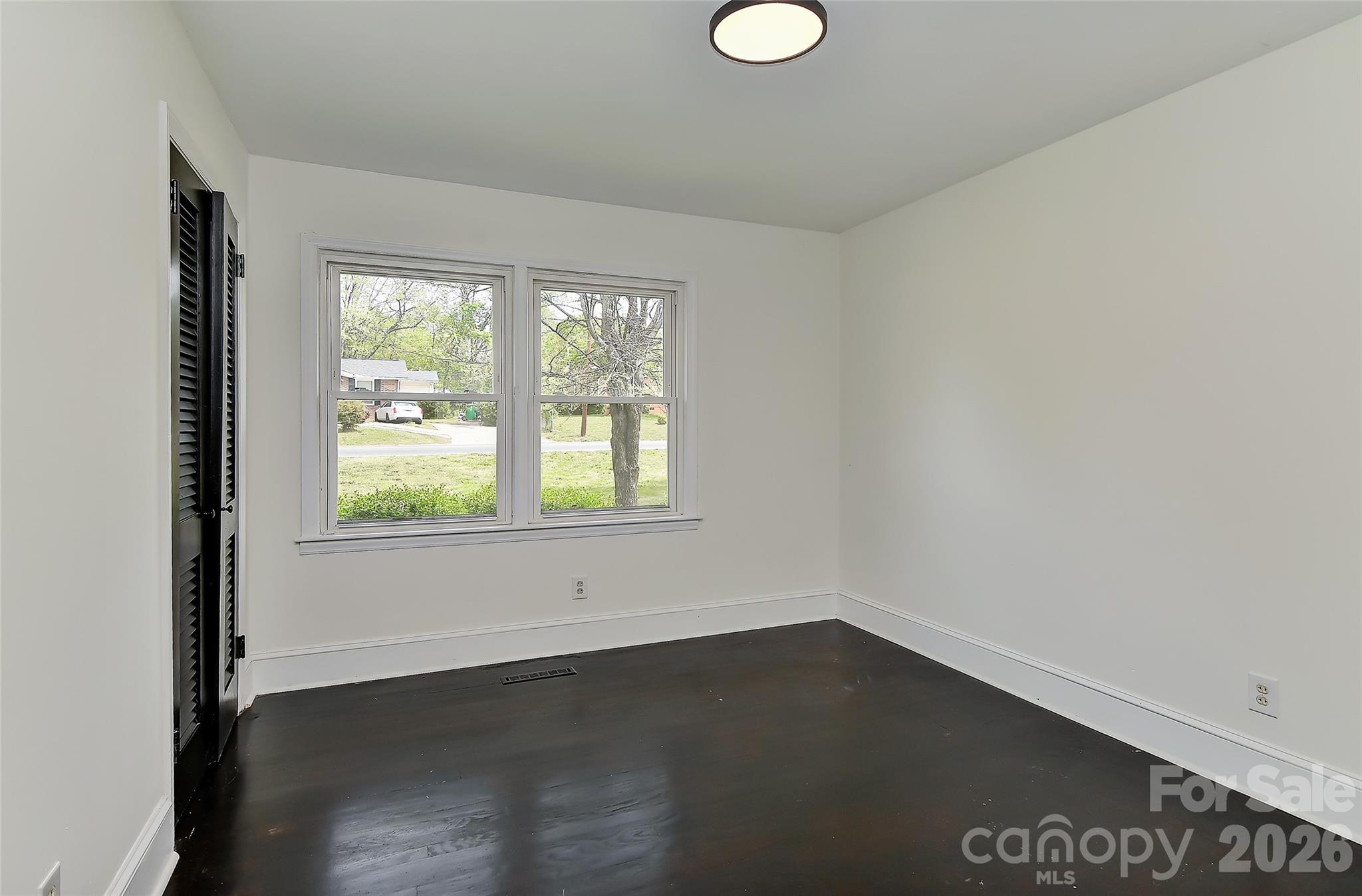 961 Clanton Road Charlotte, NC 28217 - Photo 17 of 23 an empty room with wooden floor and windows