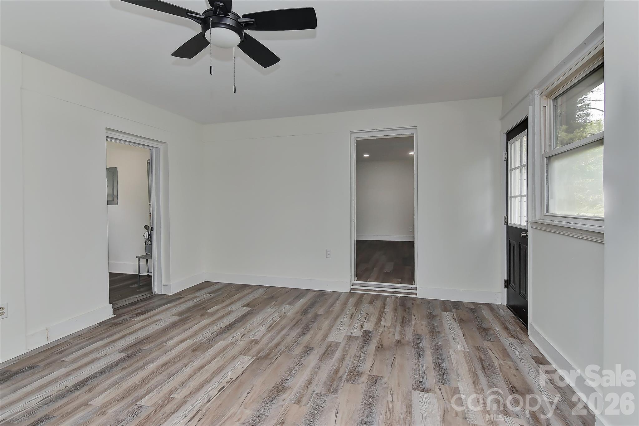 961 Clanton Road Charlotte, NC 28217 - Photo 19 of 23 a view of empty room with wooden floor and window