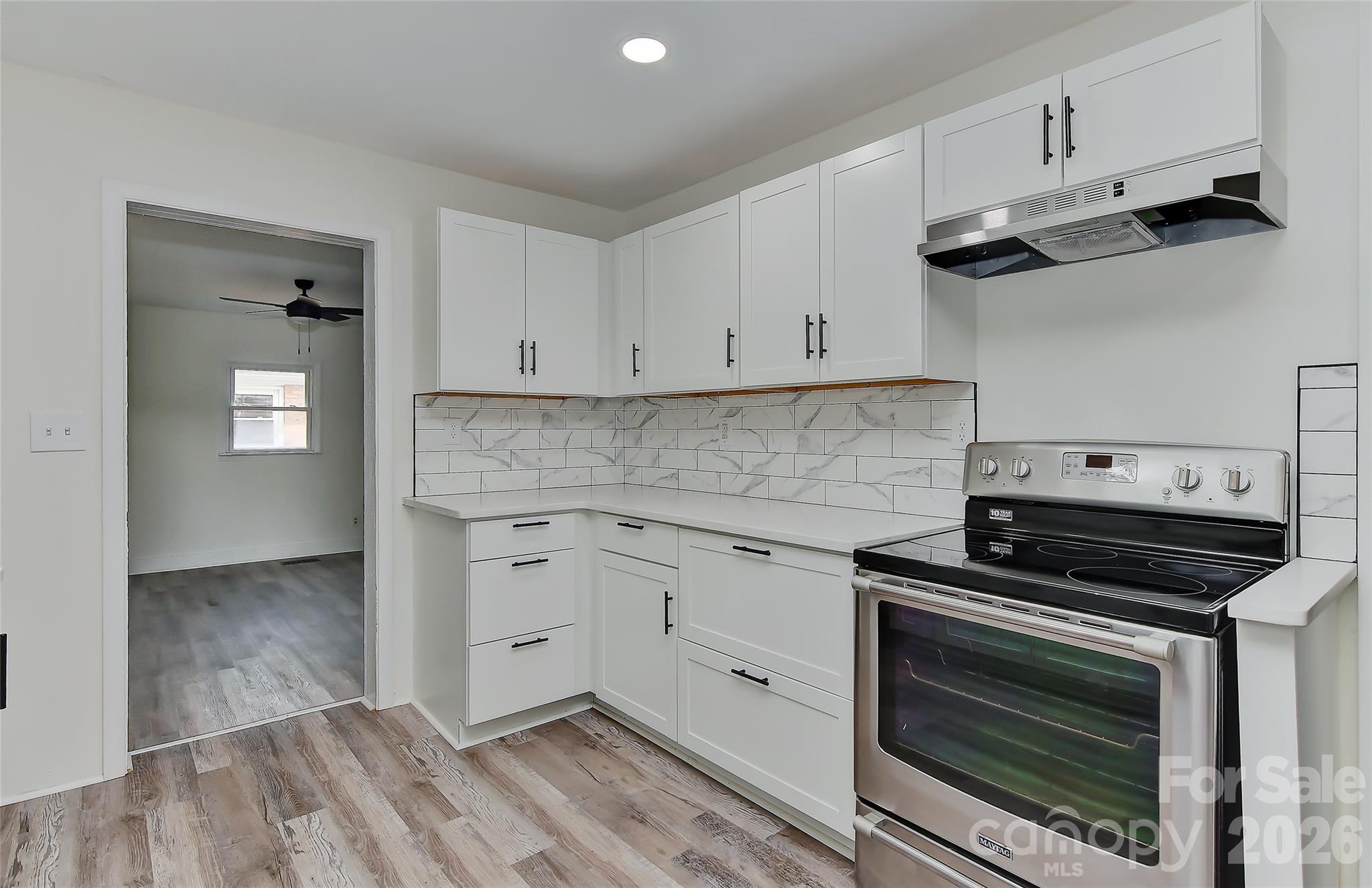 961 Clanton Road Charlotte, NC 28217 - Photo 3 of 23 a kitchen with cabinets appliances and a wooden floor