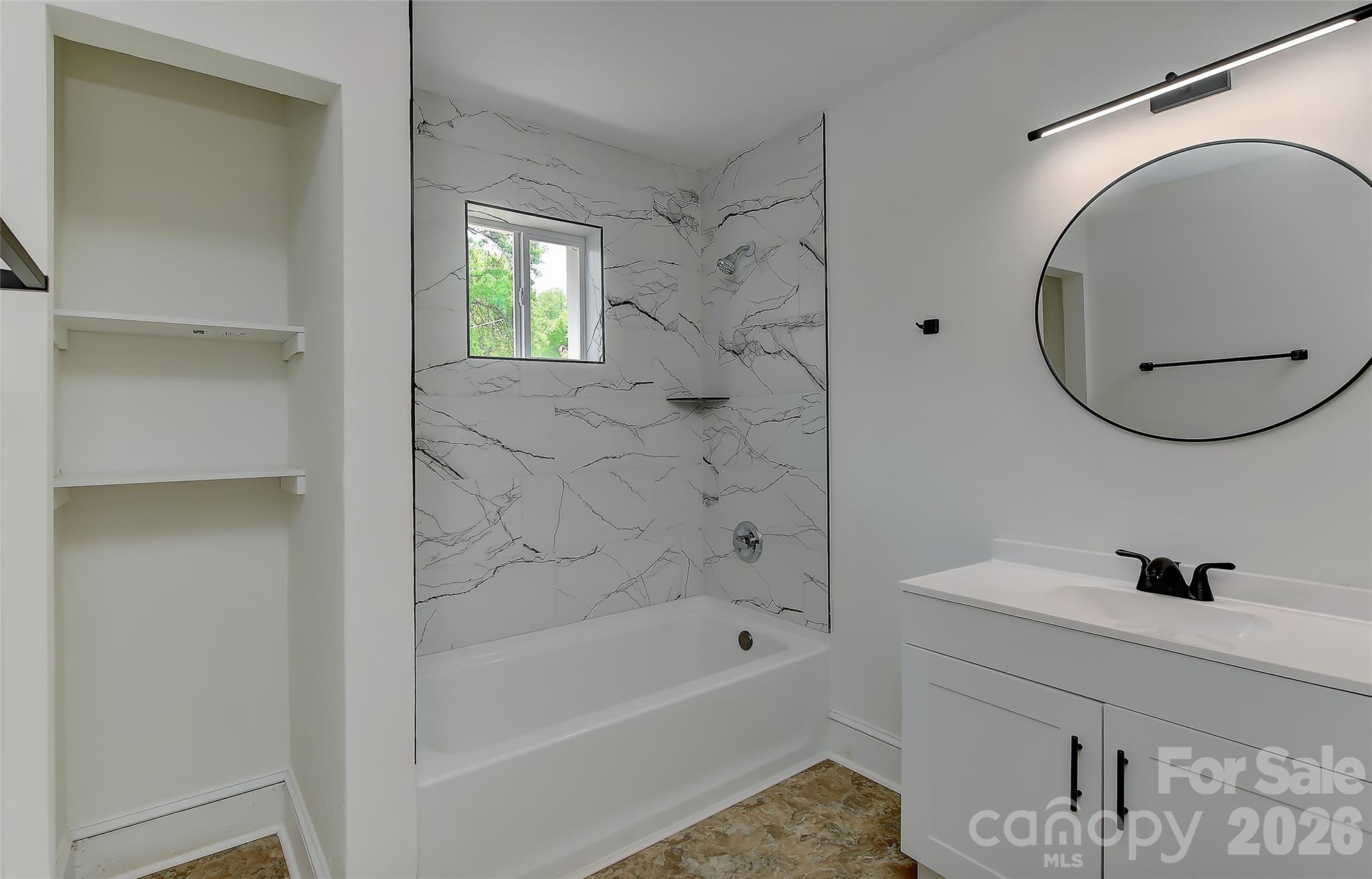 961 Clanton Road Charlotte, NC 28217 - Photo 10 of 23 a bathroom with a sink a bathtub and a mirror