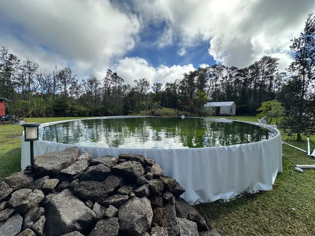 a view of a chair and a small pool in the back yard