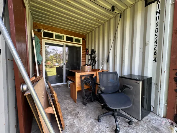 a view of balcony with furniture and a chair