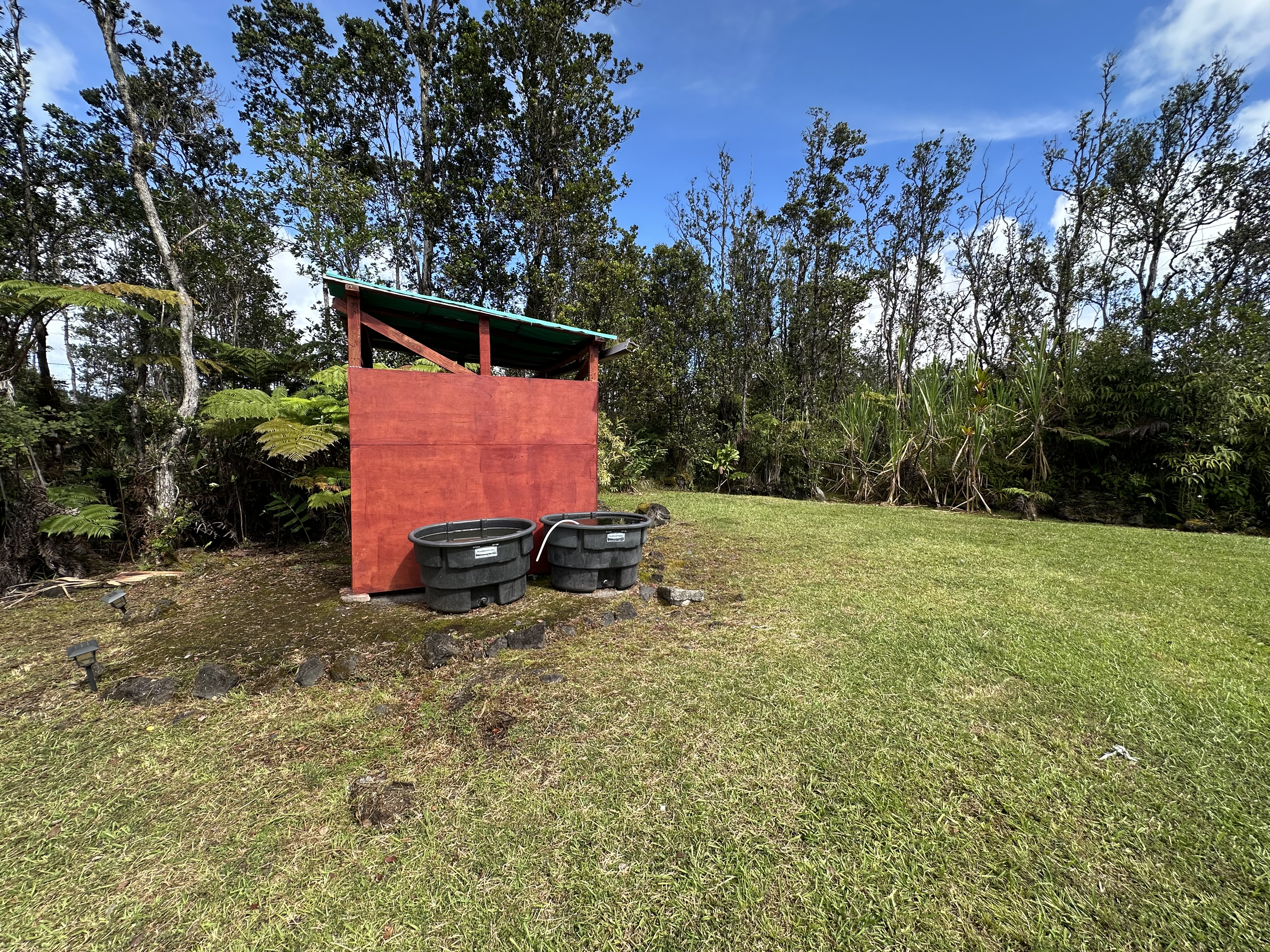 11-3003 Kahaualea Road Volcano, HI 96771 - Photo 10 of 25 a backyard of a house with parked cars