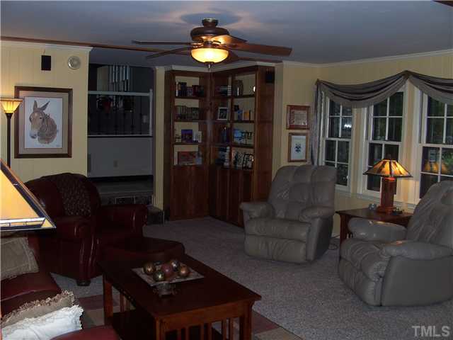 6904 Brecken Ridge Avenue Raleigh, NC 27615 - Photo 11 of 25 Here's another view of the Family Room showing even more built-in bookcases and the large windows that bring in lots of light.