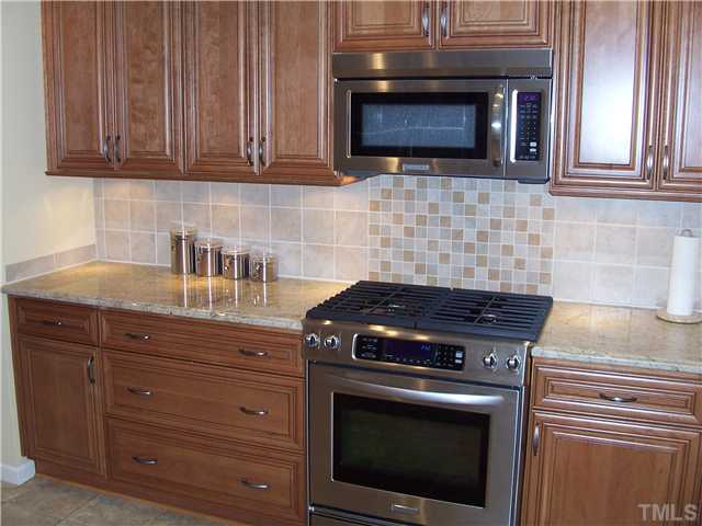 6904 Brecken Ridge Avenue Raleigh, NC 27615 - Photo 2 of 25 Stunningly remodeled kitchen has granite countertops, custom cherry cabinets with "soft close" drawers. The new gas top range and convection oven are a cook's dream.