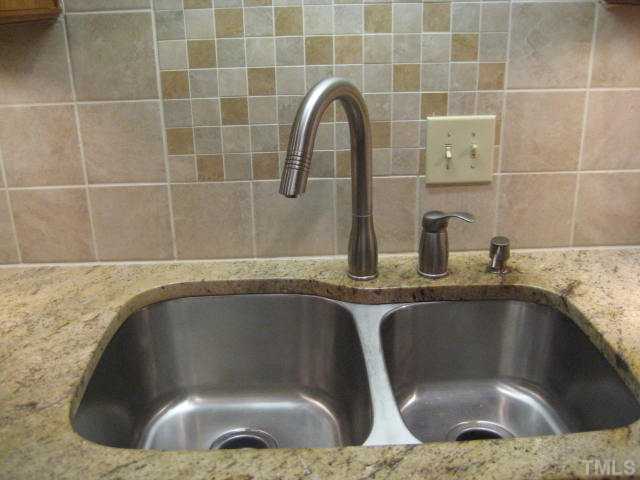 6904 Brecken Ridge Avenue Raleigh, NC 27615 - Photo 6 of 25 Undermount sink with granite countertops. You don't see this in just any house in North Raleigh.