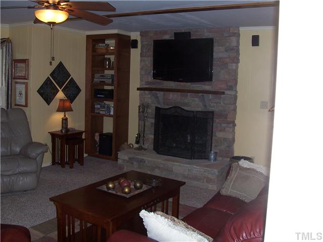 6904 Brecken Ridge Avenue Raleigh, NC 27615 - Photo 8 of 25 The Family room is perfect for spending time together. Beautiful wood burning fireplace and built-in bookshelves store electronic equipment.