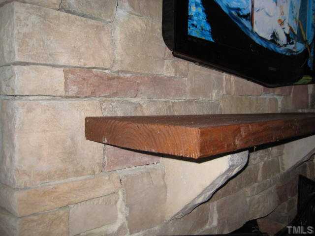 6904 Brecken Ridge Avenue Raleigh, NC 27615 - Photo 9 of 25 Stacked stone fireplace is a gorgeous feature of this home.
