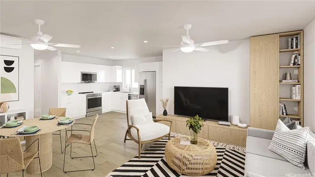 a living room with furniture a flat screen tv and kitchen view
