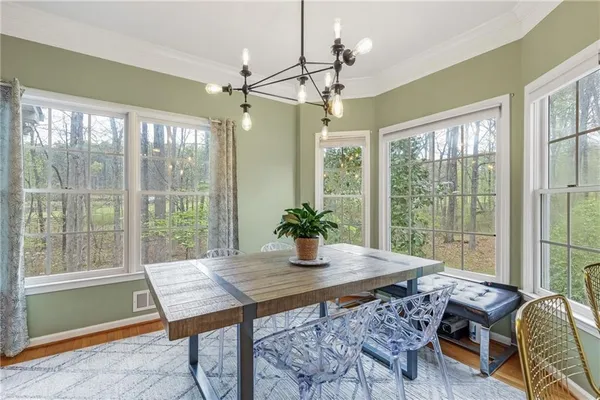 a kitchen that has a lot of cabinets in it and wooden floors
