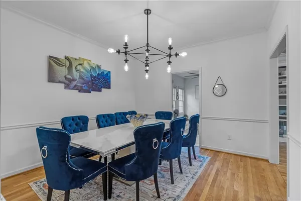 a view of a dining room with furniture and wooden floor
