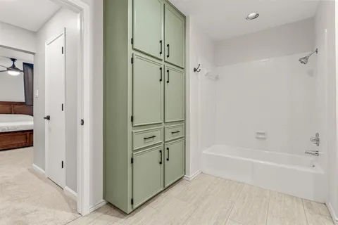 a bathroom with a tub a sink and shower