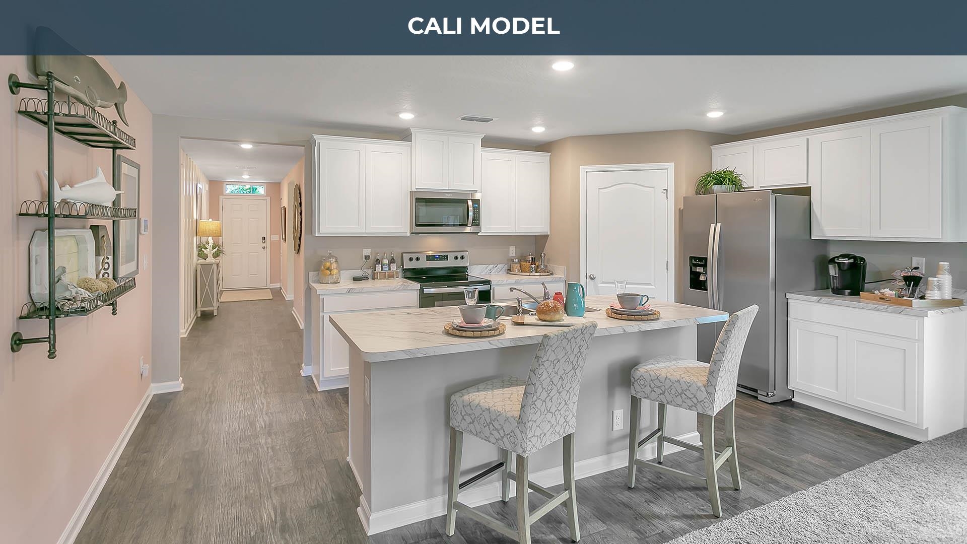 25 Postman Lane Palm Coast, FL 32164 - Photo 4 of 18 a kitchen with stainless steel appliances kitchen island granite countertop a refrigerator and a stove top oven