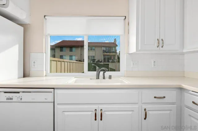 a kitchen with a sink and a window