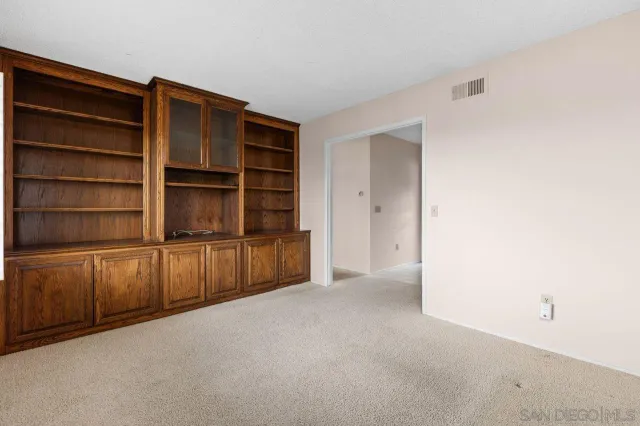 a view of an empty room with empty shelves