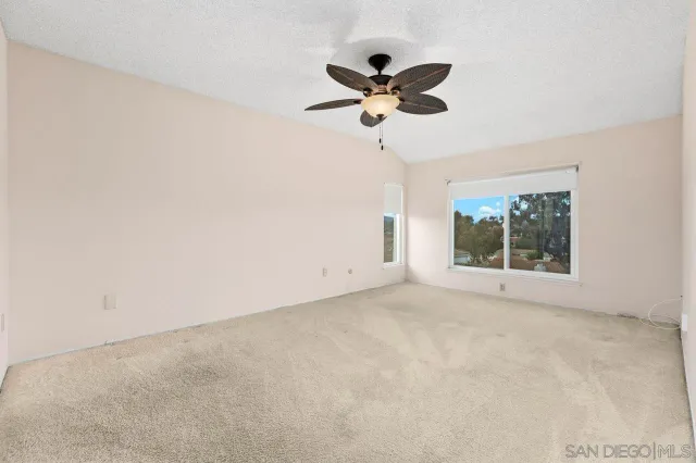 a view of a livingroom with a ceiling fan and window