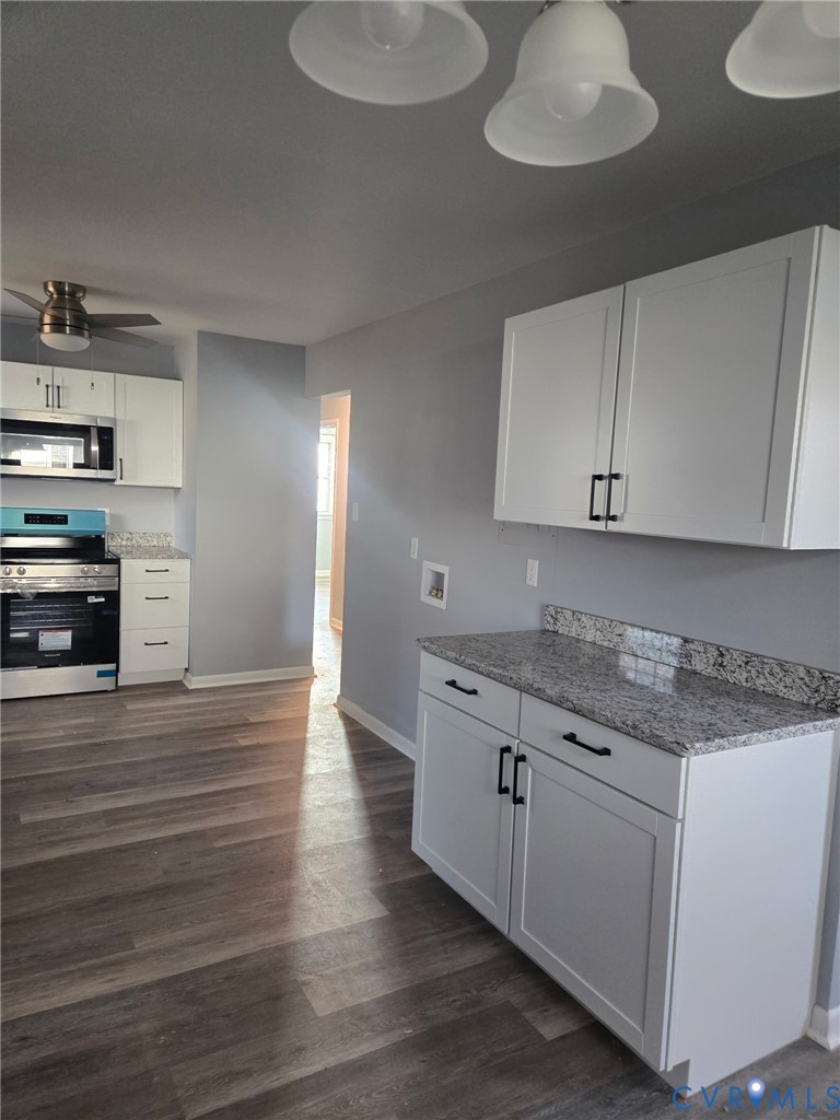 2211 Johnson Street Hopewell, VA 23860 - Photo 3 of 8 a kitchen with granite countertop a stove and a white cabinets