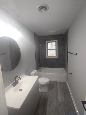 a bathroom with a sink a toilet and bathtub