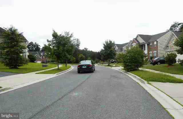 9906 Farm Pond Road Laurel, MD 20708 - Photo 3 of 11 a view of a car parked in front of a house with a big yard