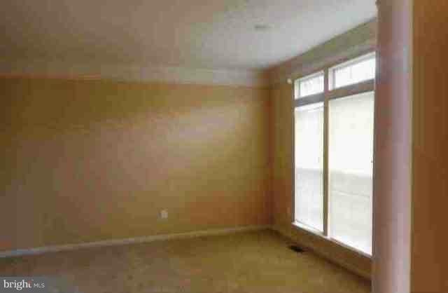 9906 Farm Pond Road Laurel, MD 20708 - Photo 5 of 11 an empty room with a window