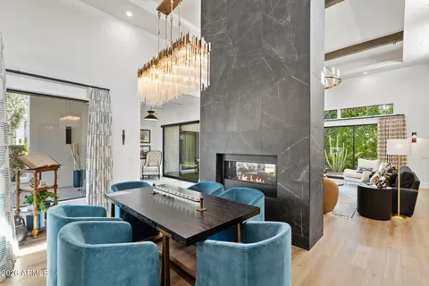 a large living room with stainless steel appliances granite countertop a couch wooden floor and a large window