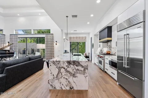 a kitchen with kitchen island granite countertop counter space a sink appliances and cabinets