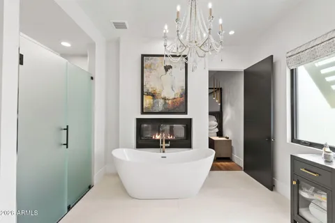 a living room with furniture a fireplace and wall paintings