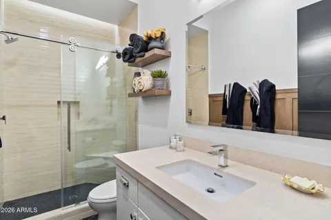 a bedroom with a bed lamp and a potted plant