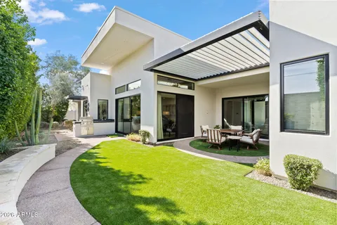 a view of a house with a swimming pool and a yard