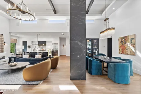 a living room with furniture a fireplace and a large window